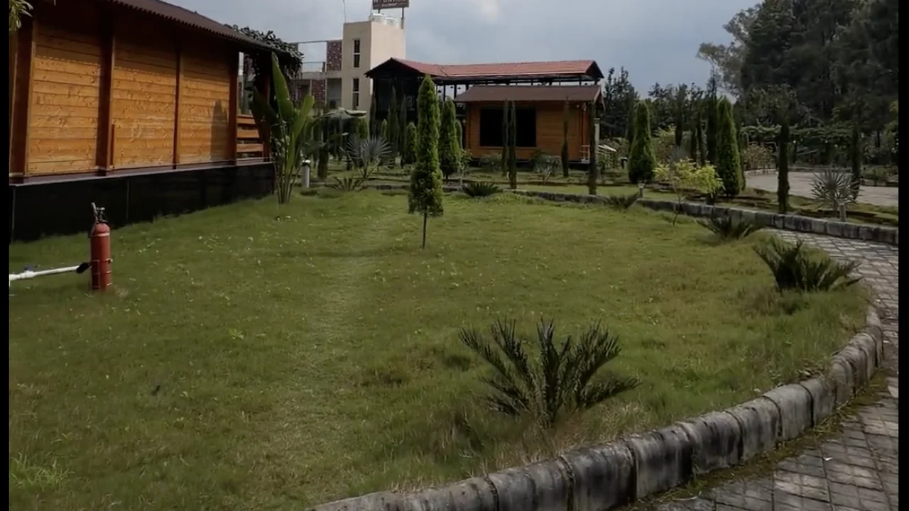 A wide view across Mountail Eco Resort's cottages, garden and grounds