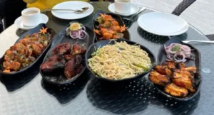 Gourmet dishes like Tandoori Chicken and Chili Paneer served at Mountail’s open-air restaurant.
