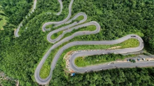 Winding forest road from Ranchi to Netarhat with green canopy